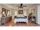 Comfortable bedroom with hardwood floors, ceiling fan, and matching dresser and nightstands at 17705 E Canyon Way, Gilbert, AZ 85298
