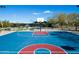 Community basketball court featuring vibrant colors, well-maintained surfaces, and ample space for recreational play at 1805 W Dusty Wren Dr, Phoenix, AZ 85085