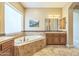 Bright bathroom with a soaking tub, large window, and vanity at 1805 W Dusty Wren Dr, Phoenix, AZ 85085