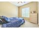 Comfortable bedroom features a dresser with a window view at 1805 W Dusty Wren Dr, Phoenix, AZ 85085