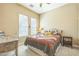 Inviting bedroom featuring a patterned quilt and ample natural light at 1805 W Dusty Wren Dr, Phoenix, AZ 85085