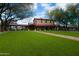 Community clubhouse with green turf, well-manicured landscape, outdoor seating, and elegant architecture at 1805 W Dusty Wren Dr, Phoenix, AZ 85085