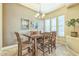 Elegant dining room featuring a stylish chandelier, decorative wall art, and natural light at 1805 W Dusty Wren Dr, Phoenix, AZ 85085