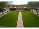 Community event lawn with brick pathway and meticulous landscaping providing a beautiful venue for gatherings at 1805 W Dusty Wren Dr, Phoenix, AZ 85085