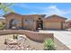 Charming home featuring stone accents, desert landscaping, a spacious garage, and a welcoming entrance with excellent curb appeal at 1805 W Dusty Wren Dr, Phoenix, AZ 85085