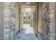 Inviting front entrance with stone archway, decorative metal gate, and paver walkway at 1805 W Dusty Wren Dr, Phoenix, AZ 85085