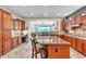 Spacious kitchen with granite countertops, custom cabinets, tile backsplash, and a center island with bar seating at 1805 W Dusty Wren Dr, Phoenix, AZ 85085