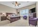 Spacious main bedroom has a ceiling fan, two chairs, and a view to the outside at 1805 W Dusty Wren Dr, Phoenix, AZ 85085