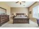 Comfortable main bedroom featuring a ceiling fan and dark wood furniture at 1805 W Dusty Wren Dr, Phoenix, AZ 85085