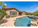 Inviting backyard pool featuring a spa, rock accents, and a well-manicured brick patio; perfect for outdoor relaxation and entertainment at 1805 W Dusty Wren Dr, Phoenix, AZ 85085