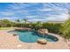 Lush backyard oasis showcasing a sparkling pool with a waterfall feature, surrounded by tropical landscaping for ultimate relaxation at 1805 W Dusty Wren Dr, Phoenix, AZ 85085