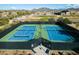 Aerial view of well-maintained tennis courts in a community setting with mountain views at 1805 W Dusty Wren Dr, Phoenix, AZ 85085