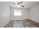 This bright bedroom features a ceiling fan and wood-style laminate flooring at 18202 N Cave Creek Rd # 122, Phoenix, AZ 85032