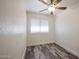 This bedroom features a ceiling fan, blinds, and wood-style laminate flooring at 18202 N Cave Creek Rd # 122, Phoenix, AZ 85032