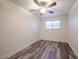 This bedroom features wood-look floors, a ceiling fan, and a window at 18202 N Cave Creek Rd # 122, Phoenix, AZ 85032
