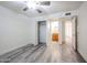Bright bedroom with a ceiling fan, wood-look floors, closet and ensuite bathroom at 18202 N Cave Creek Rd # 122, Phoenix, AZ 85032