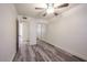 Well-lit bedroom with wood-look floors, a closet, and access to a bathroom at 18202 N Cave Creek Rd # 122, Phoenix, AZ 85032