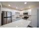 This bright kitchen features white cabinets, a stainless steel fridge, and a stainless steel stove at 18202 N Cave Creek Rd # 122, Phoenix, AZ 85032