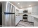 Bright kitchen featuring stainless steel appliances, white cabinets, and sleek countertops at 18202 N Cave Creek Rd # 122, Phoenix, AZ 85032