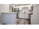 Open concept kitchen with stainless steel appliances, white cabinets, and a breakfast bar at 18202 N Cave Creek Rd # 122, Phoenix, AZ 85032