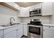 This kitchen features stainless steel appliances, white cabinets, and granite countertops at 18202 N Cave Creek Rd # 122, Phoenix, AZ 85032
