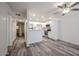 Open concept living room with bright natural light, ceiling fan, and vinyl flooring at 18202 N Cave Creek Rd # 122, Phoenix, AZ 85032