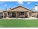 Inviting backyard with covered patio, outdoor seating, and artificial grass at 18845 N 23Rd Pl, Phoenix, AZ 85024