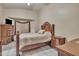 Spacious bedroom with tiled floors, TV, decorative curtains, and wooden furniture at 18845 N 23Rd Pl, Phoenix, AZ 85024