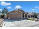 Charming single-story home with a well-manicured lawn and paved driveway at 18845 N 23Rd Pl, Phoenix, AZ 85024