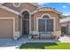 Attractive home exterior with stone accents, a charming front bench, and well-kept landscaping, showing street view at 18845 N 23Rd Pl, Phoenix, AZ 85024