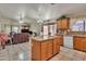 Open concept kitchen with granite countertops, an island, and seamless flow to the adjacent living spaces at 18845 N 23Rd Pl, Phoenix, AZ 85024