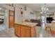 Open kitchen with island, granite countertop, and view into the living room at 18845 N 23Rd Pl, Phoenix, AZ 85024