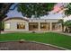 Beautiful backyard featuring lush green lawn, desert landscaping, and covered patio at 19902 S 190Th St, Queen Creek, AZ 85142