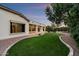 The back of the home overlooks a large grass area and mature landscaping at 19902 S 190Th St, Queen Creek, AZ 85142