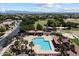 A high-angle aerial view of the community pool and surrounding green spaces, mature landscaping and mountain views at 19902 S 190Th St, Queen Creek, AZ 85142