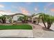 Inviting desert home with mature palms, well manicured lawn, and a stone facade at 19902 S 190Th St, Queen Creek, AZ 85142