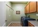 Laundry room with modern washer and dryer, ample cabinetry, and tile flooring at 19902 S 190Th St, Queen Creek, AZ 85142