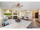 Inviting living room with a cozy fireplace, ceiling fan, and an entertainment center at 19902 S 190Th St, Queen Creek, AZ 85142