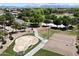 This is an aerial view of the community splash pad, sand volleyball court, and adjacent green space with mountain views at 19902 S 190Th St, Queen Creek, AZ 85142