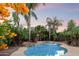 Sparkling pool and spa surrounded by lush landscaping create a serene backyard retreat at 19902 S 190Th St, Queen Creek, AZ 85142