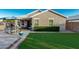View of backyard featuring a patio with umbrella-covered seating and neat synthetic turf at 2070 E Saddlebrook Ct, Gilbert, AZ 85298