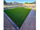 The well-maintained backyard includes artificial turf, patio pavers and gravel at 2070 E Saddlebrook Ct, Gilbert, AZ 85298