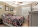 Cozy bedroom featuring hardwood floors, a ceiling fan, and a charming window with curtains at 2070 E Saddlebrook Ct, Gilbert, AZ 85298