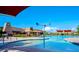 Inviting community pool featuring fun water features, lounge chairs, and shaded seating areas on a clear, sunny day at 2070 E Saddlebrook Ct, Gilbert, AZ 85298
