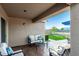 Relaxing covered patio with seating area, views of the backyard and greenery at 2070 E Saddlebrook Ct, Gilbert, AZ 85298