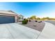 Long driveway leading to a two-car garage with desert landscaping at 2070 E Saddlebrook Ct, Gilbert, AZ 85298