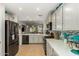Well-equipped kitchen with stainless steel appliances, white cabinets, and a colorful backsplash at 2070 E Saddlebrook Ct, Gilbert, AZ 85298