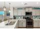 Modern kitchen featuring white countertops, stainless steel appliances, and stylish pendant lighting at 2070 E Saddlebrook Ct, Gilbert, AZ 85298