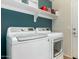 Well-equipped laundry room with a modern washer and dryer, plus convenient shelving at 2070 E Saddlebrook Ct, Gilbert, AZ 85298