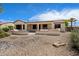 Backyard shows a spacious covered patio with an outdoor kitchen and desert landscaping at 20900 N Vista Trl, Surprise, AZ 85387